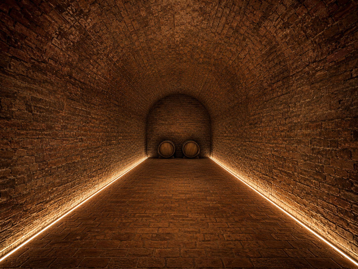 Restored brick barrel-vaulted wine cellar lit along the floor line, two oak barrels at the far end